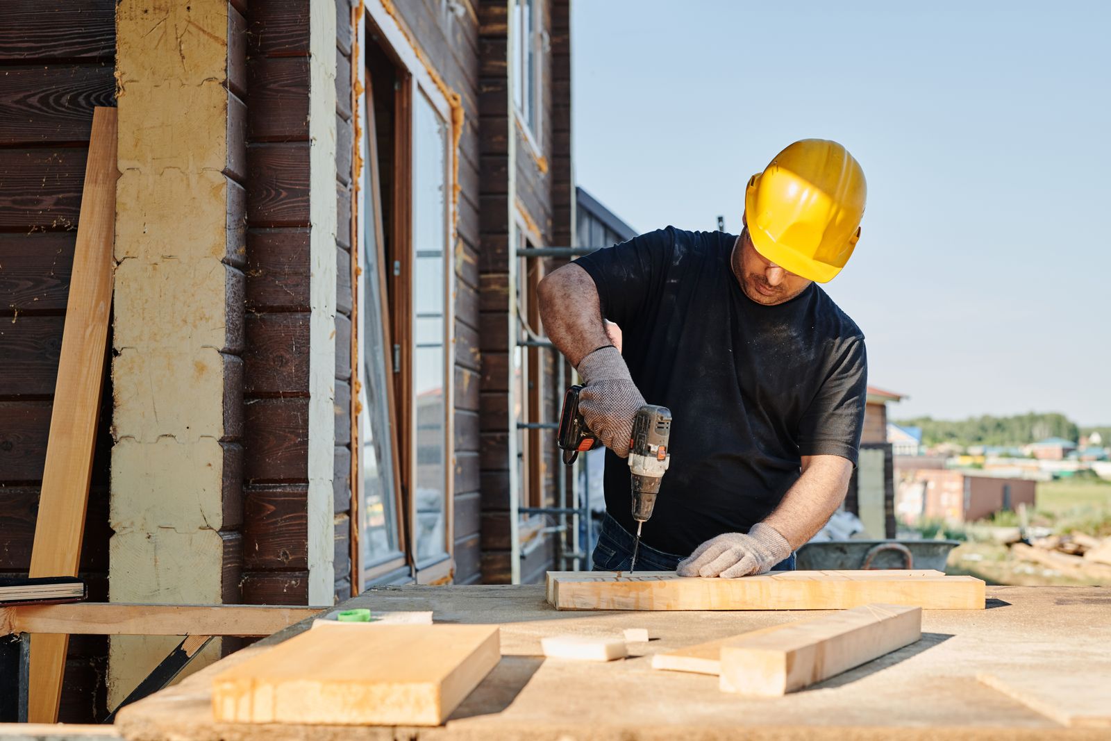 A craftsperson carefully working on a timber structure